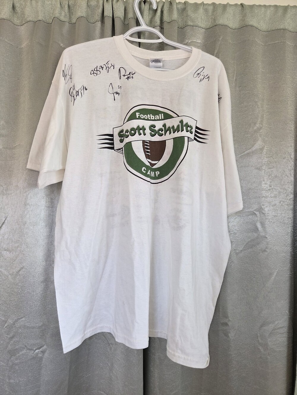 Schultz White T-Shirt with Green and Brown Football Logo Autographed.